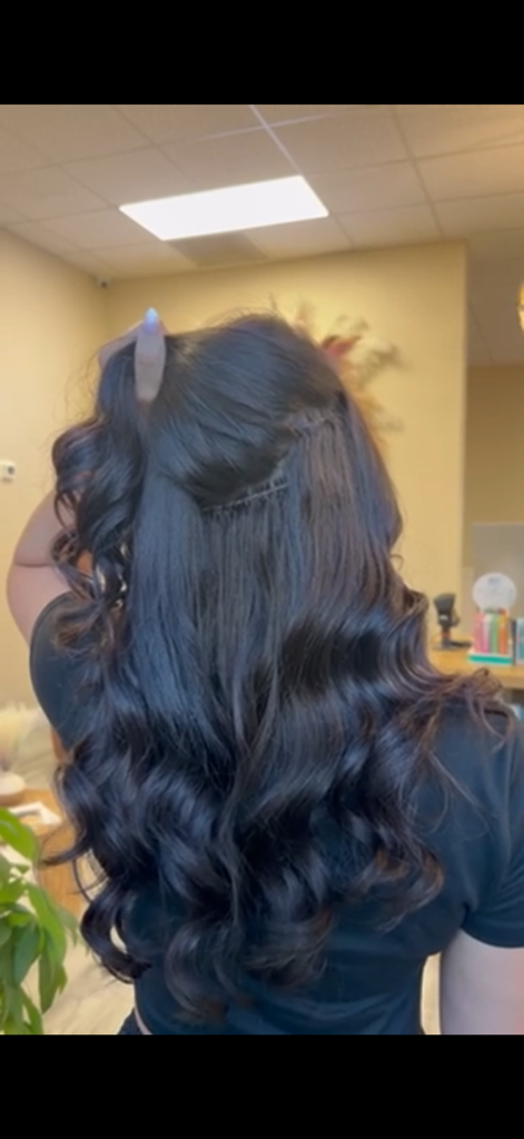 Long dark hair with a discreet extension row and glossy curls